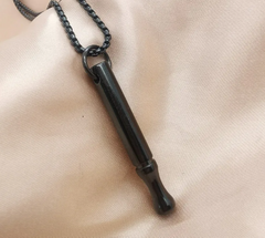 Black whistle pendant necklace on soft fabric, stylish and functional gift idea