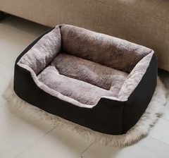 Cozy gray and black pet bed for dogs or cats, soft plush interior, placed on fluffy rug near sofa