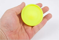 Bright yellow stress ball held in hand, perfect for relaxation and fun gifts