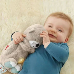 Happy baby hugging gray plush cat toy with soft fur and light-up belly, perfect baby gift