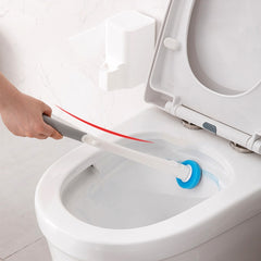 Hand using long-handled toilet brush with blue head to clean white toilet bowl