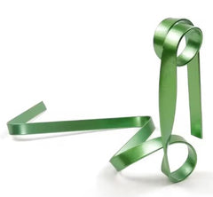 Shiny green gift ribbon curled elegantly for holiday wrapping and festive decoration