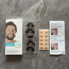 Nasal dilator starter kit with black silicone strips, adhesive tabs, and usage guide for better breathing during sleep or sports