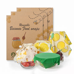 Reusable beeswax food wraps with lemon and honeycomb designs covering bowls