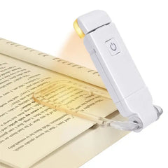 White LED book light with clip, illuminating pages for reading in bed or low light