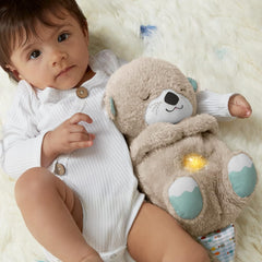 Baby with plush otter toy featuring soft fur, glowing belly light, and cozy design for newborns and infants