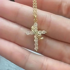 Gold cross necklace with clear gemstones, held in hand, perfect gift for family
