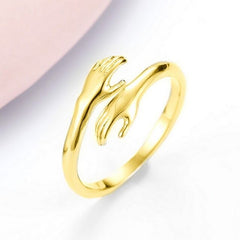 Gold ring with intertwined hands design, elegant gift for loved ones
