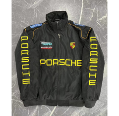 Black Porsche racing jacket with yellow lettering, sponsor logos, and Motorsport design on marble background