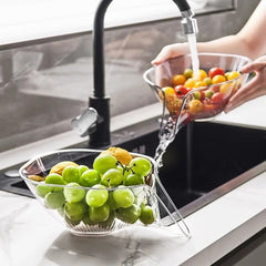 Clear fruit washing bowl with grapes and cherry tomatoes under kitchen faucet, perfect for family meal prep
