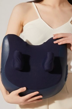 Navy blue cat-shaped neck massager held by woman, ergonomic design for relaxation and comfort