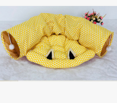 Yellow triangle-patterned cat tunnel with playful ears and pom-poms, perfect for pet playtime