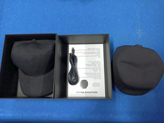 Black therapeutic cap with USB cable and manual in gift box, ideal for pain relief and wellness gifts