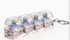 Clear acrylic keychain with blue-tinted mechanical keyboard switches, perfect gift for tech lovers
