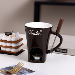 Chocolate fondue mug with candle heater and fork, perfect for sweet treats and cozy gatherings