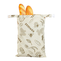 Beeswax food wrap bag with bread, featuring bee and honeycomb print for eco-friendly storage