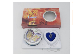 Heart-shaped blue velvet necklace box with silver pendant, gift tin, and 'Love' themed packaging