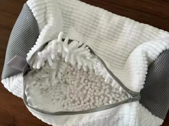 Soft white plush pet bed with gray mesh sides and cozy textured interior, perfect for family pets
