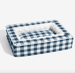 Blue and white checkered pet bed with soft white lining, cozy dog or cat resting spot