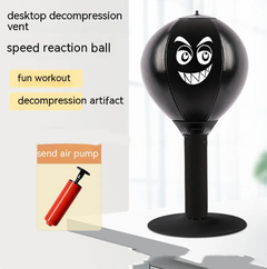 Black desktop punching ball with funny face for stress relief and fun workout, includes air pump