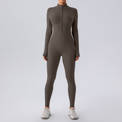 Women's olive green long sleeve zip-up jumpsuit with white sneakers, perfect for fitness or casual wear.