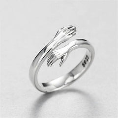 Sterling silver ring with intertwined hands design, perfect for family or couple gifts