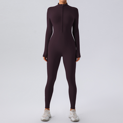 Purple long-sleeve zip-front bodysuit with leggings, paired with white sneakers for casual or workout wear