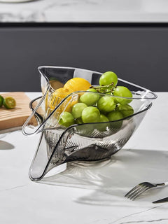 Clear acrylic fruit bowl with grapes and lemons, modern kitchen countertop decor