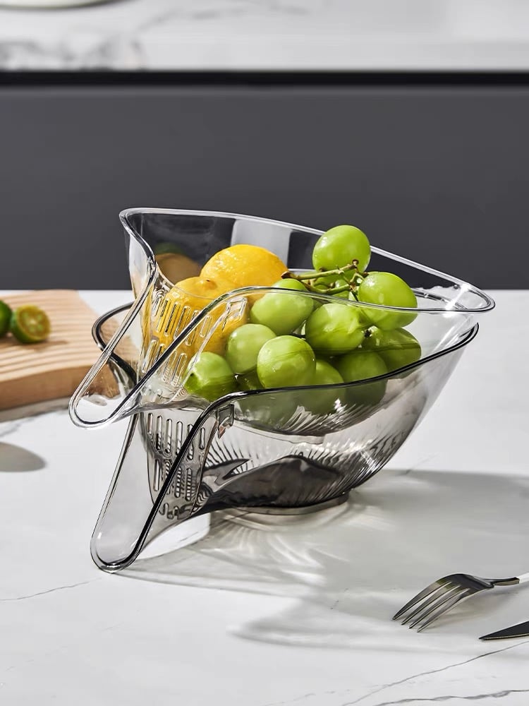 Clear acrylic fruit bowl with grapes and lemons, modern kitchen countertop decor