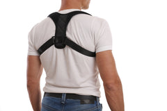 Man wearing black posture corrector brace for back support and alignment