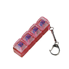 Red 4-compartment pill organizer with keychain, ideal for daily medication storage and travel