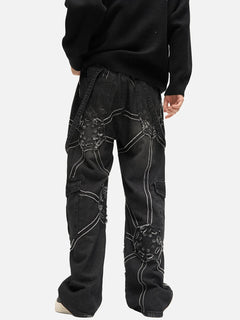 Black distressed cargo jeans with white stitching and ripped patches, styled with a black sweater