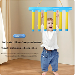 Toddler playing with blue and yellow hanging reaction game for kids' responsiveness training