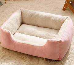 Pink and cream plush pet bed for cats or small dogs, cozy and soft on fluffy rug