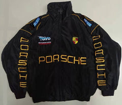 Black Porsche racing jacket with gold embroidery, Team TOYO logo, and Sparco patches, ideal for motorsport fans