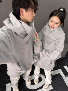 Couple in matching oversized gray hoodies, stylish streetwear for couples, cozy and trendy look
