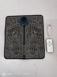 EMS foot massager mat with remote and USB cable, black and white design for relaxation and wellness