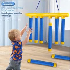Child playing hand-eye coordination game with blue and yellow hanging tubes for sensory training