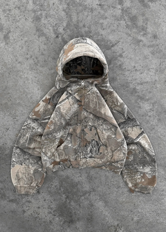 Camouflage zip-up hoodie with hood, laid flat on gray concrete background, perfect for outdoor gifts