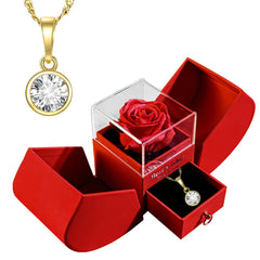 Elegant gold pendant necklace with crystal charm, presented in red gift box with preserved rose