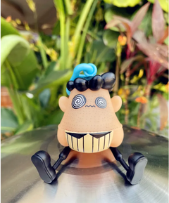 Funny cartoon figurine with spiral eyes, blue hair, and big smile, perfect quirky gift for family