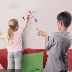 Kids playing with colorful magnetic fish toys on wall, fun family activity