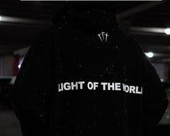 Black hoodie with 'LIGHT OF THE WORLD' text and starry design, perfect gift for family and friends