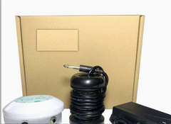 Compact aquarium air pump with coiled black tubing, power adapter, and white control unit beside cardboard box