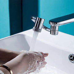 Hands washing under chrome faucet with water stream, modern bathroom sink