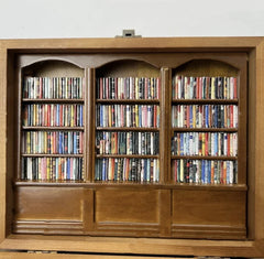Wooden bookshelf filled with colorful DVDs, perfect gift for movie lovers and home decor