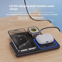 Wireless charging pad charging phone, smartwatch, and Bluetooth earbuds simultaneously on wooden desk