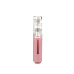 Pink handheld electric facial cleansing brush with clear head and charging base