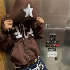 Brown hoodie with white star and graphic print, worn in elevator