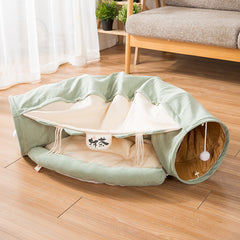 Green cat tunnel bed with cozy hideaway and hanging toy for indoor pets
